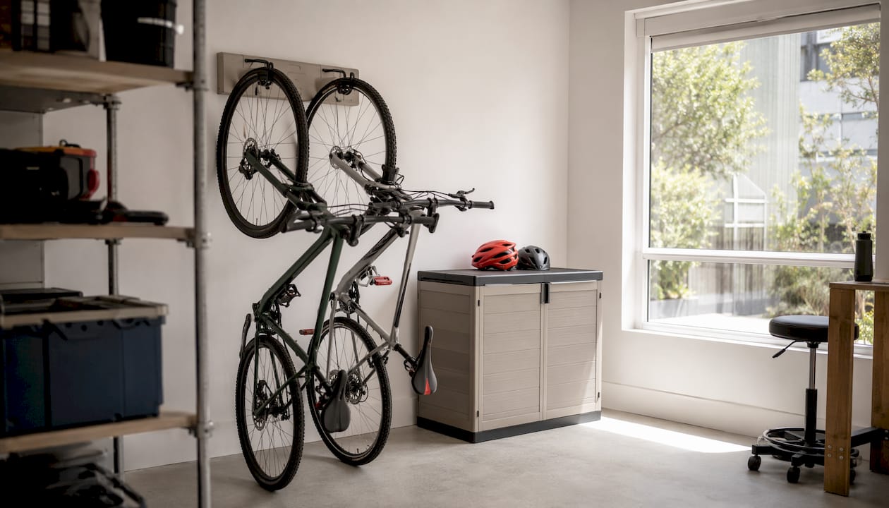Keter wall-mounted bike rack with padded hooks in garage