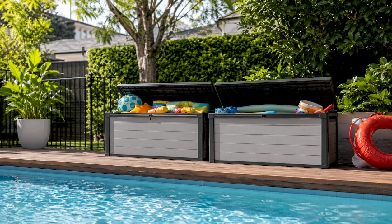 Stacked Keter modular pool storage boxes outdoors