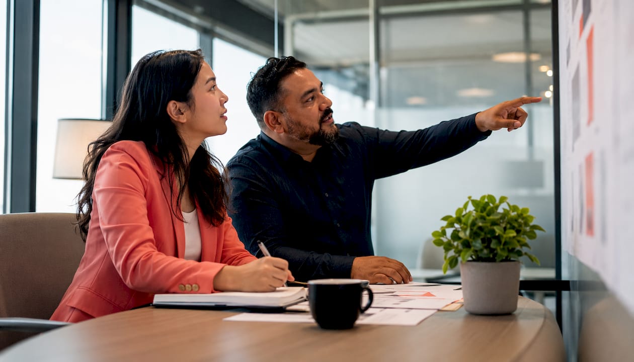 Two marketers discussing negative keyword strategy