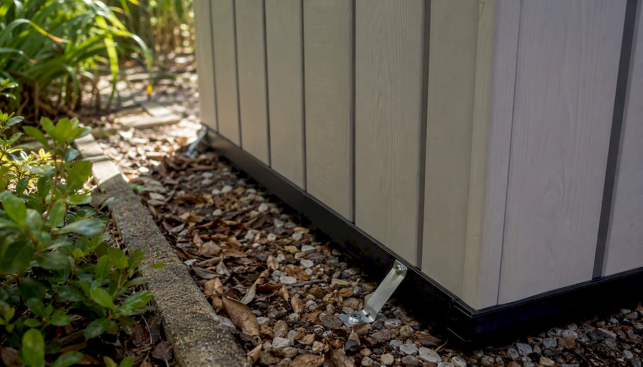 Close-up anchoring detail on resin shed base