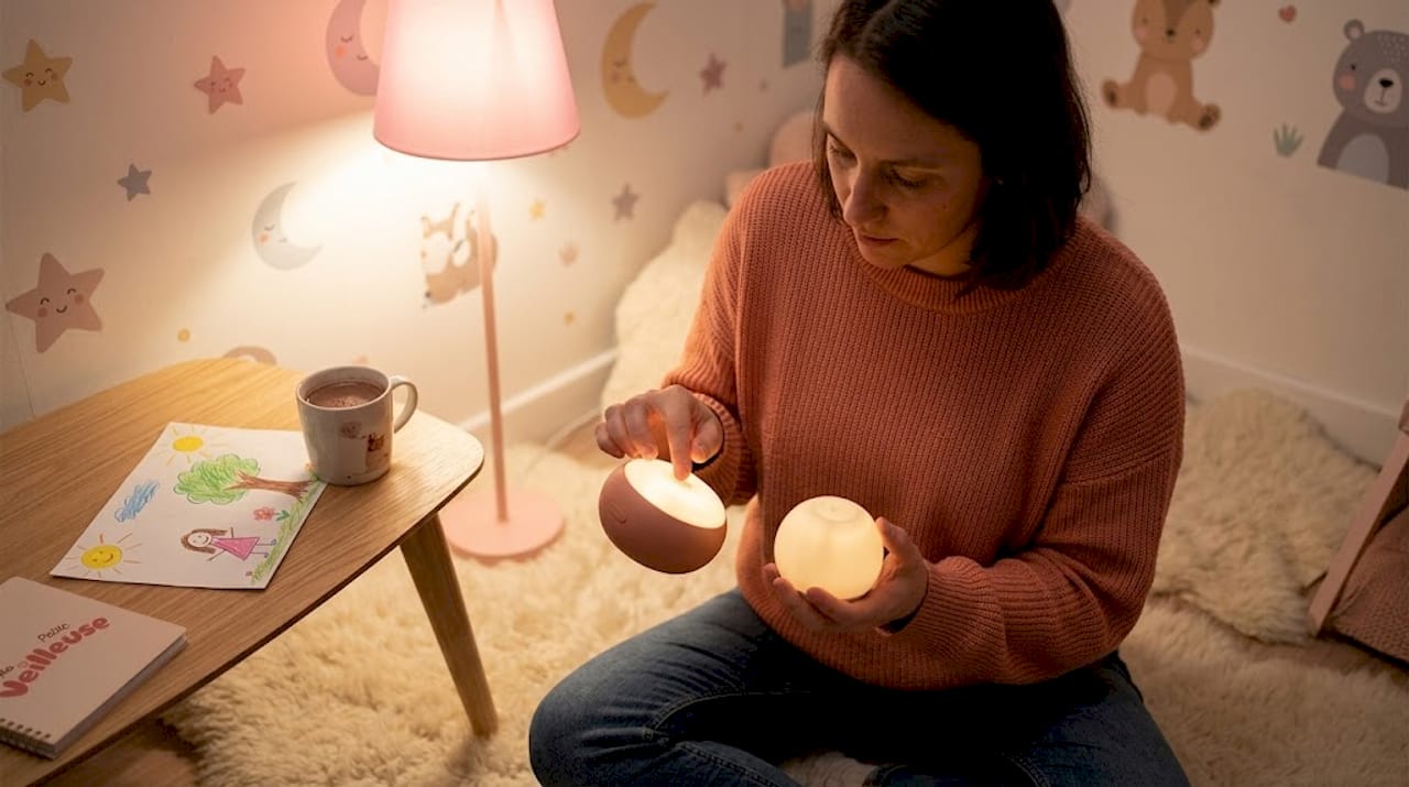 Un parent qui compare deux veilleuses tactiles pour le salon