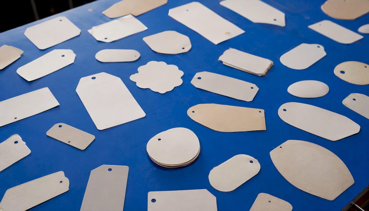 Different sizes of custom hang tags on fabric