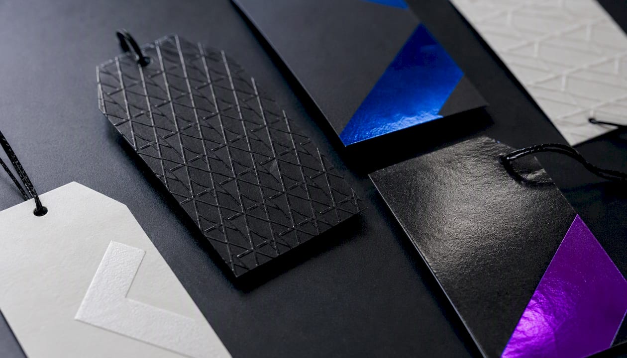 Close-up of textured and foil hang tag finishes