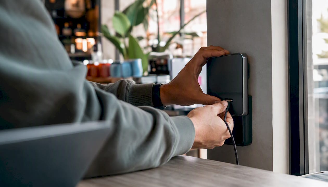 Hands plugging in custom charging cable