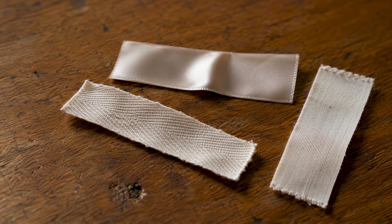 Close-up of satin, twill, and cotton label materials