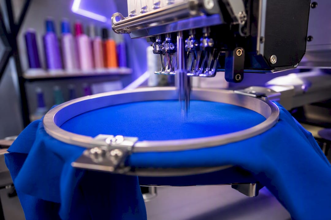 Embroidery hoop holding fabric on machine