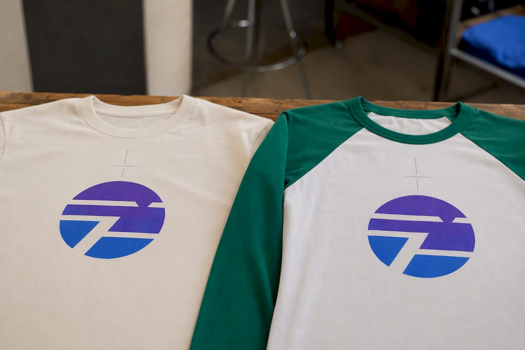 Top view of crew neck and raglan shirts with centered prints