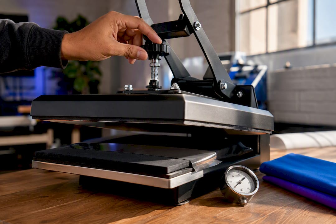 Technician adjusting heat press pressure