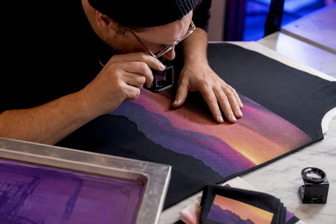 Printer inspecting halftone garment proof