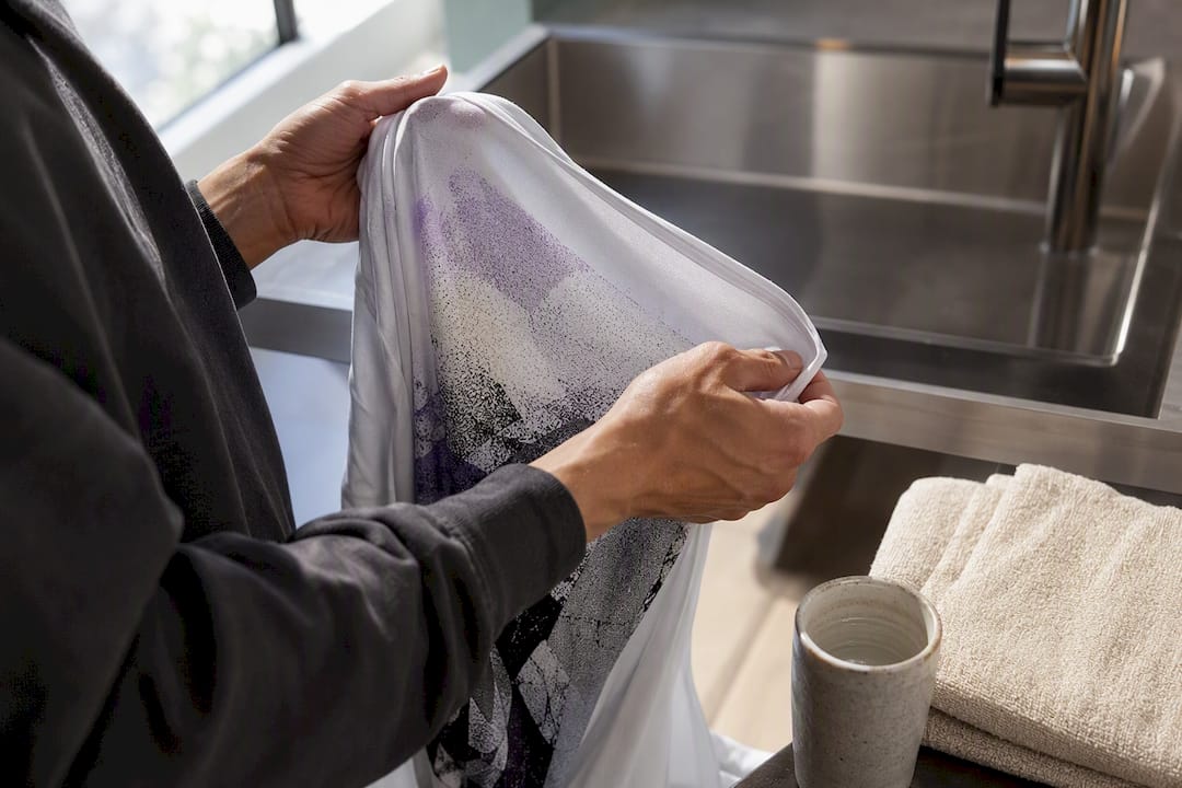 Hands turning printed fabric inside out
