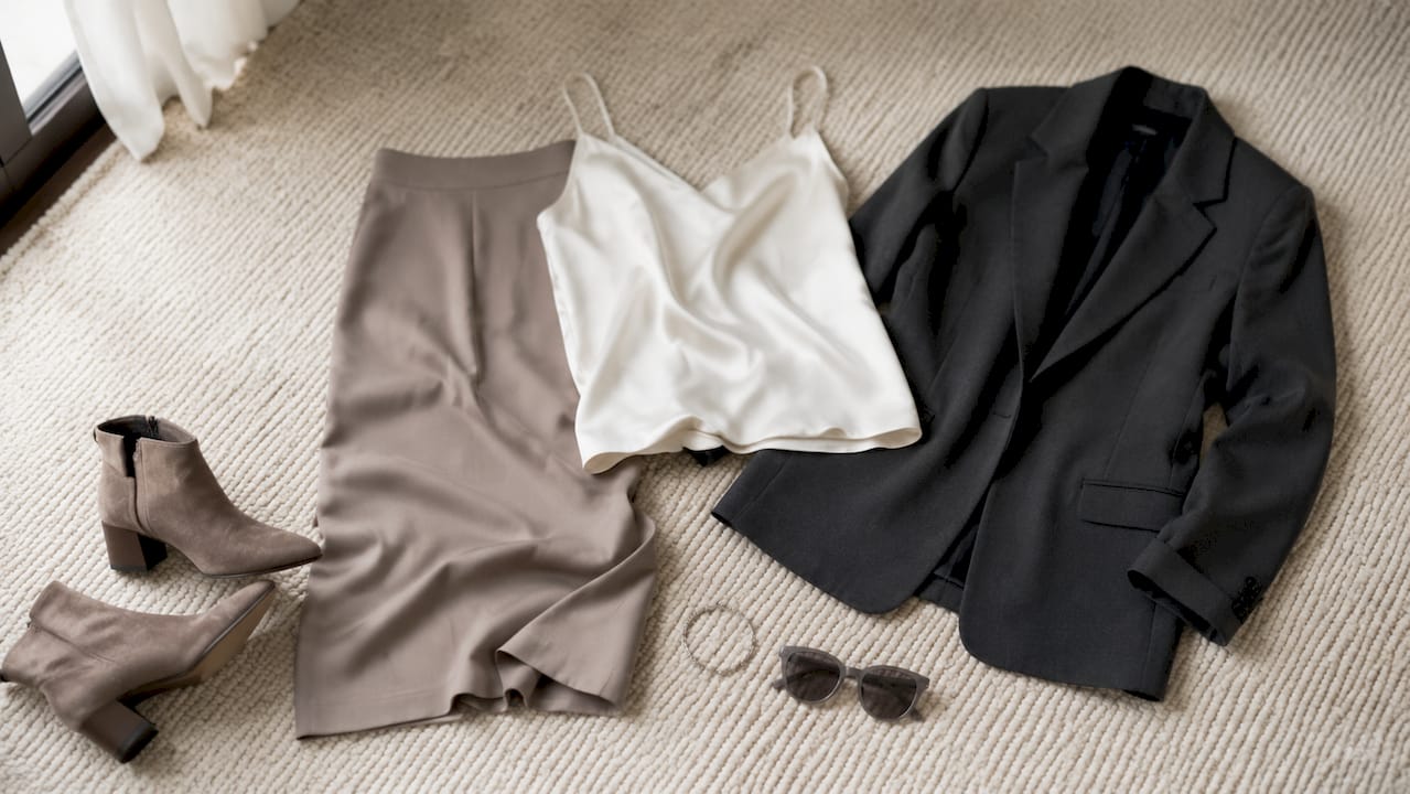 Flat lay of neutral tone versatile outfit base