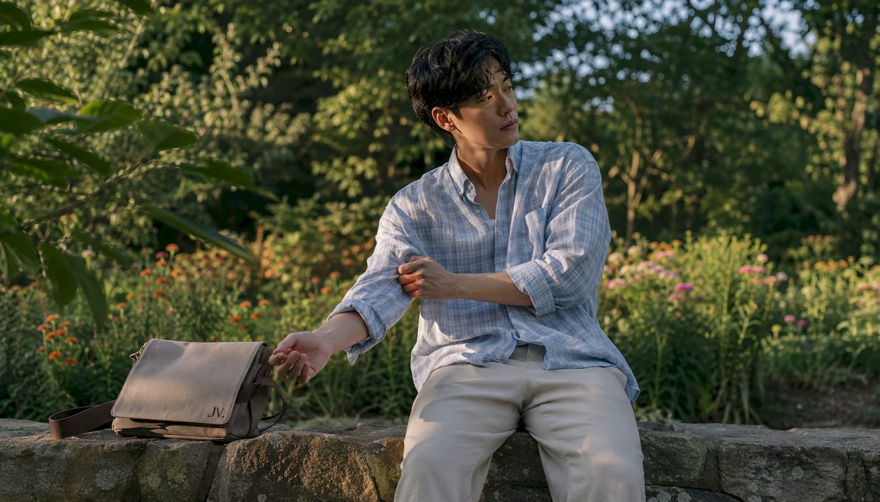 Man styling relaxed fit trousers and fitted shirt
