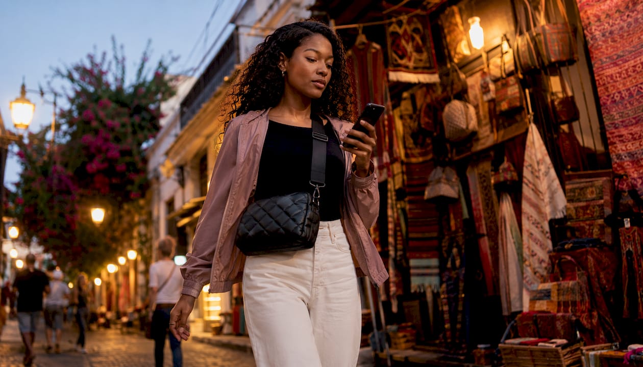Woman walking with black crossbody bag