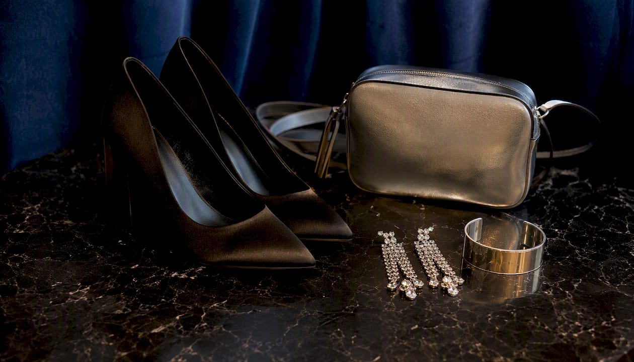 Close-up of black tie shoes and accessories