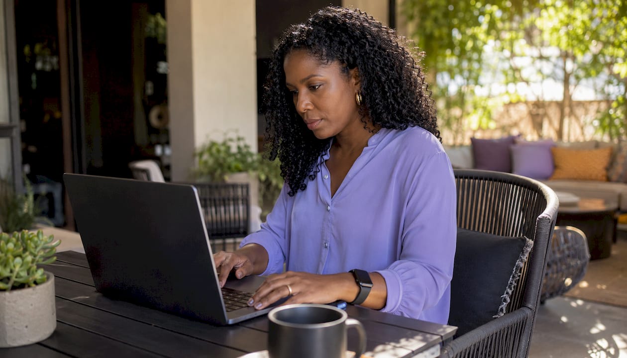 Woman typing authentic AI LinkedIn post in home office