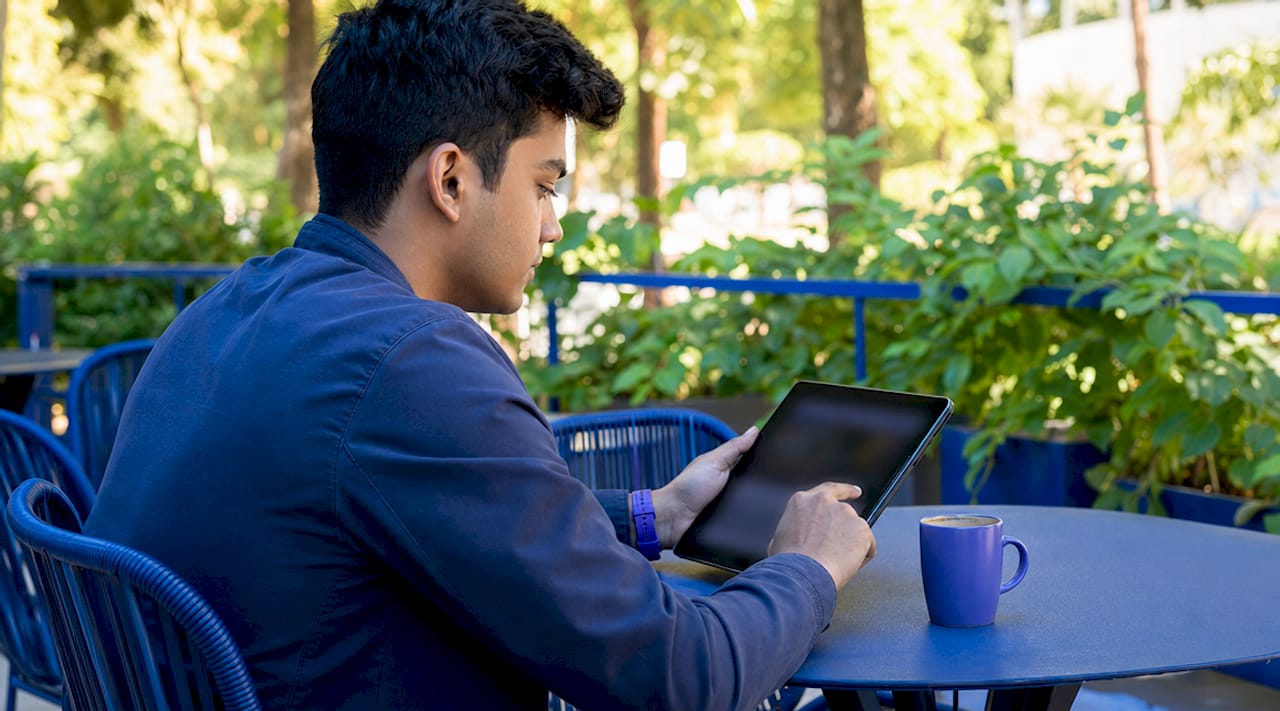 Close-up hands using AI website builder tablet