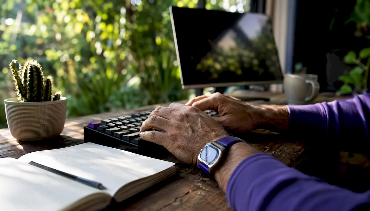 Hands typing on keyboard in creative office