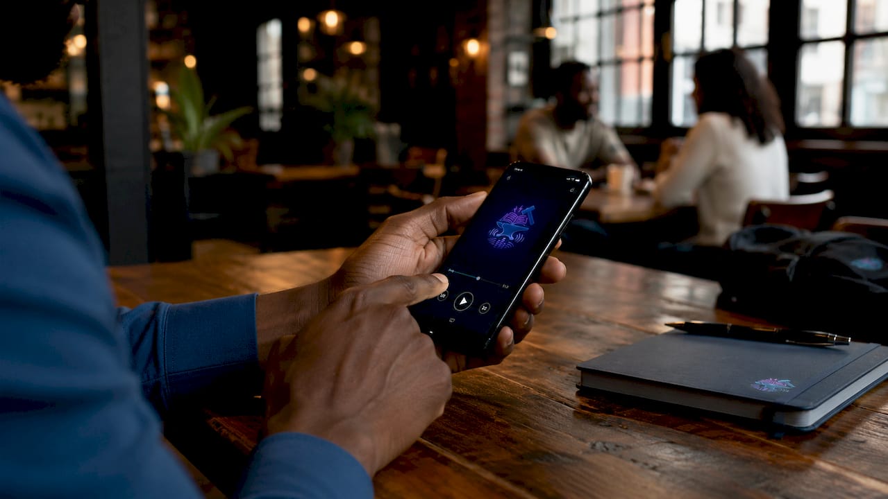 Hand adjusting audiobook speed on smartphone