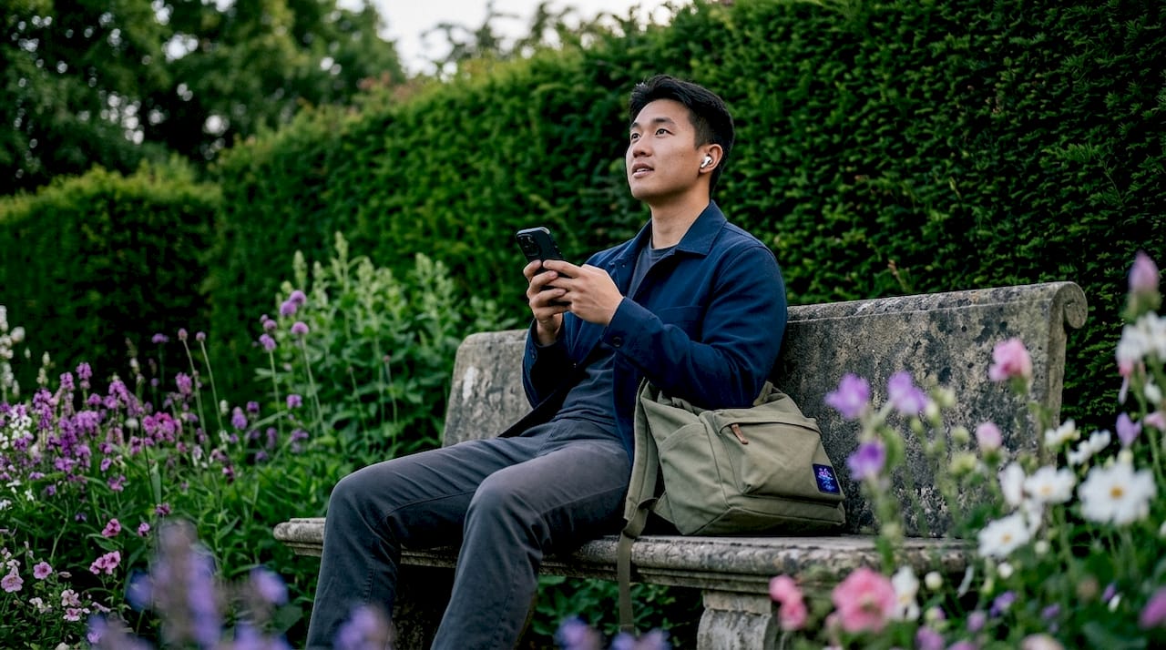 Man listening to podcast outdoors in park
