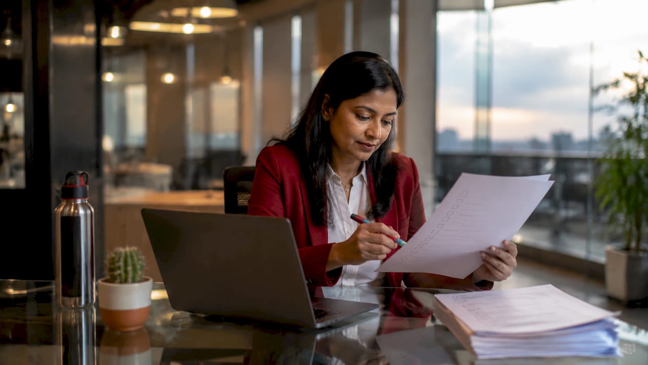 Office manager reviewing IT support checklist