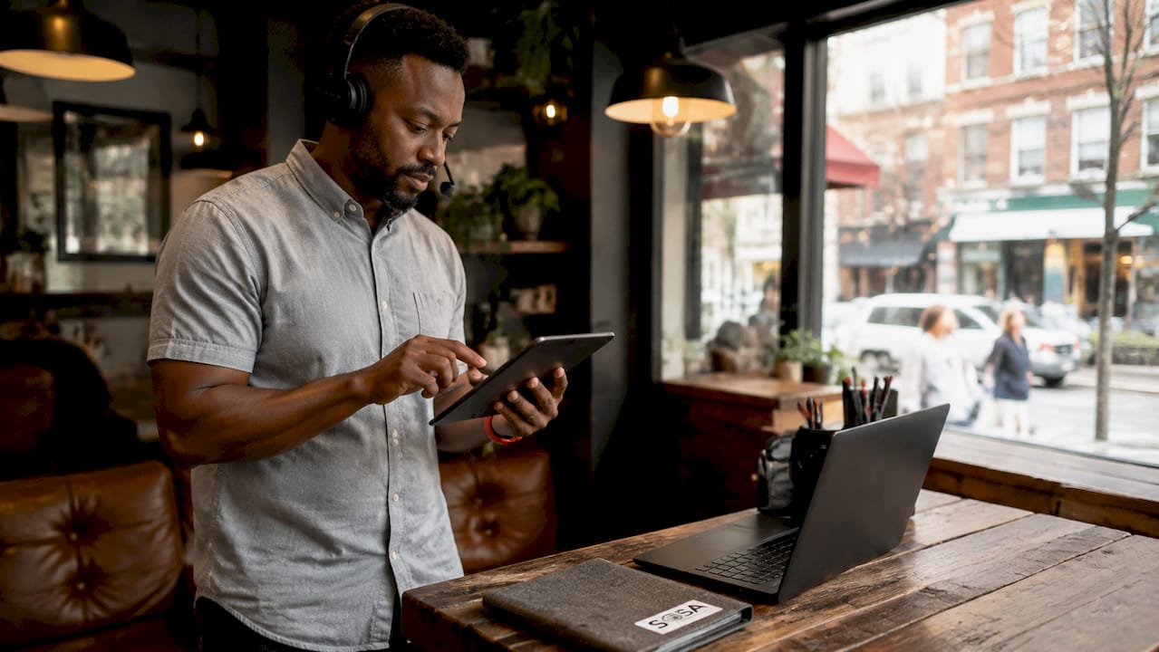 Retail IT support technician using tablet in back office