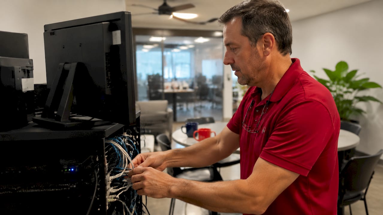 Technician configuring point of sale network cables