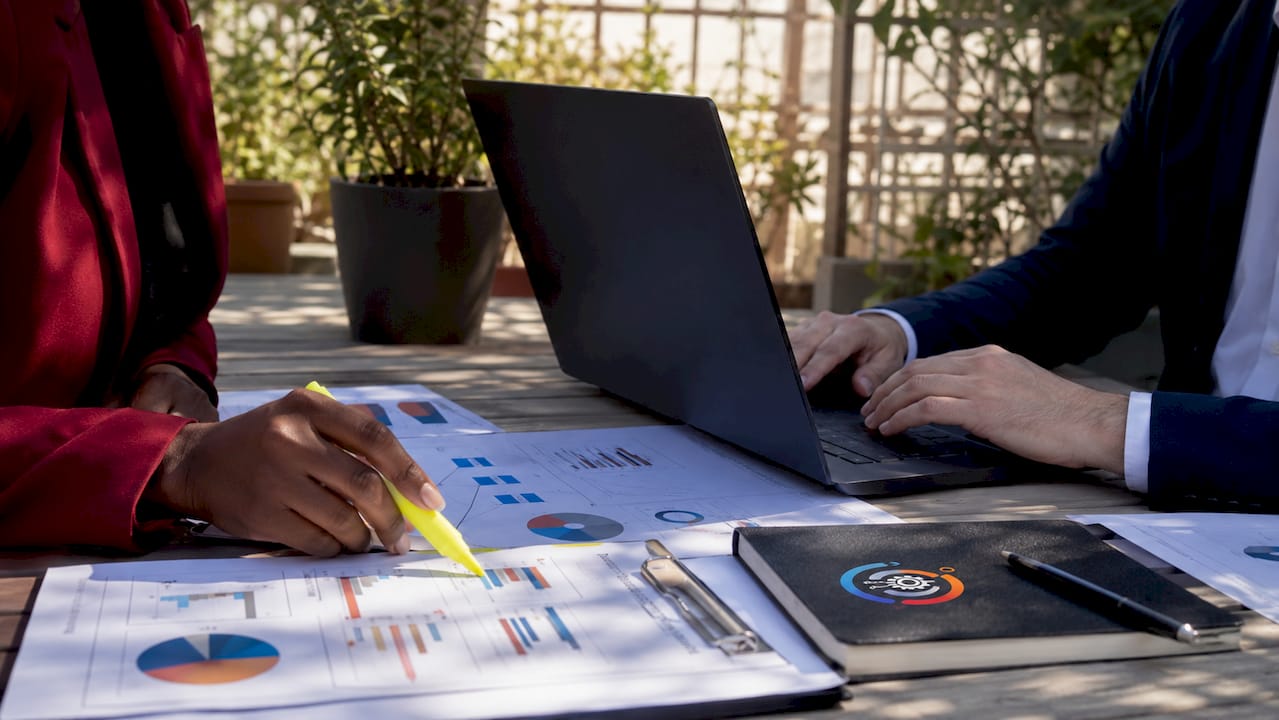 Hands reviewing vendor lifecycle documents in meeting
