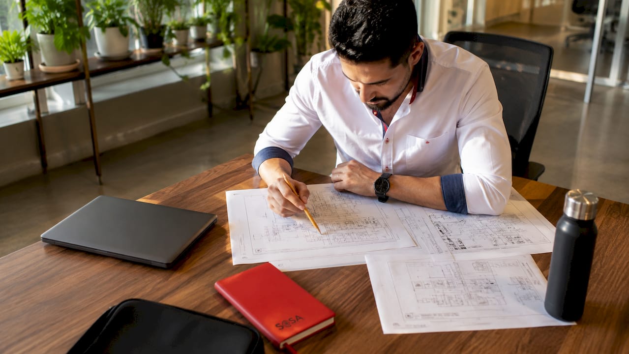 Engineer reviewing retail expansion network diagrams