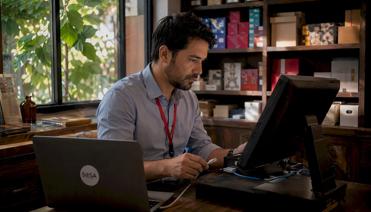 Technician troubleshooting retail IT system failure