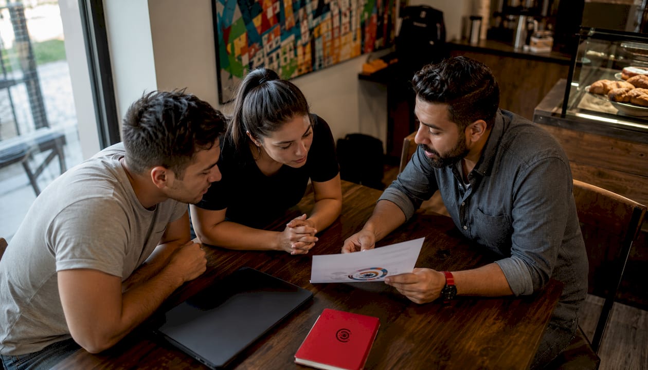 Store manager coaching retail staff in break room