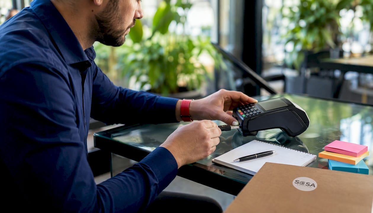 Hands interacting with POS device and security tools