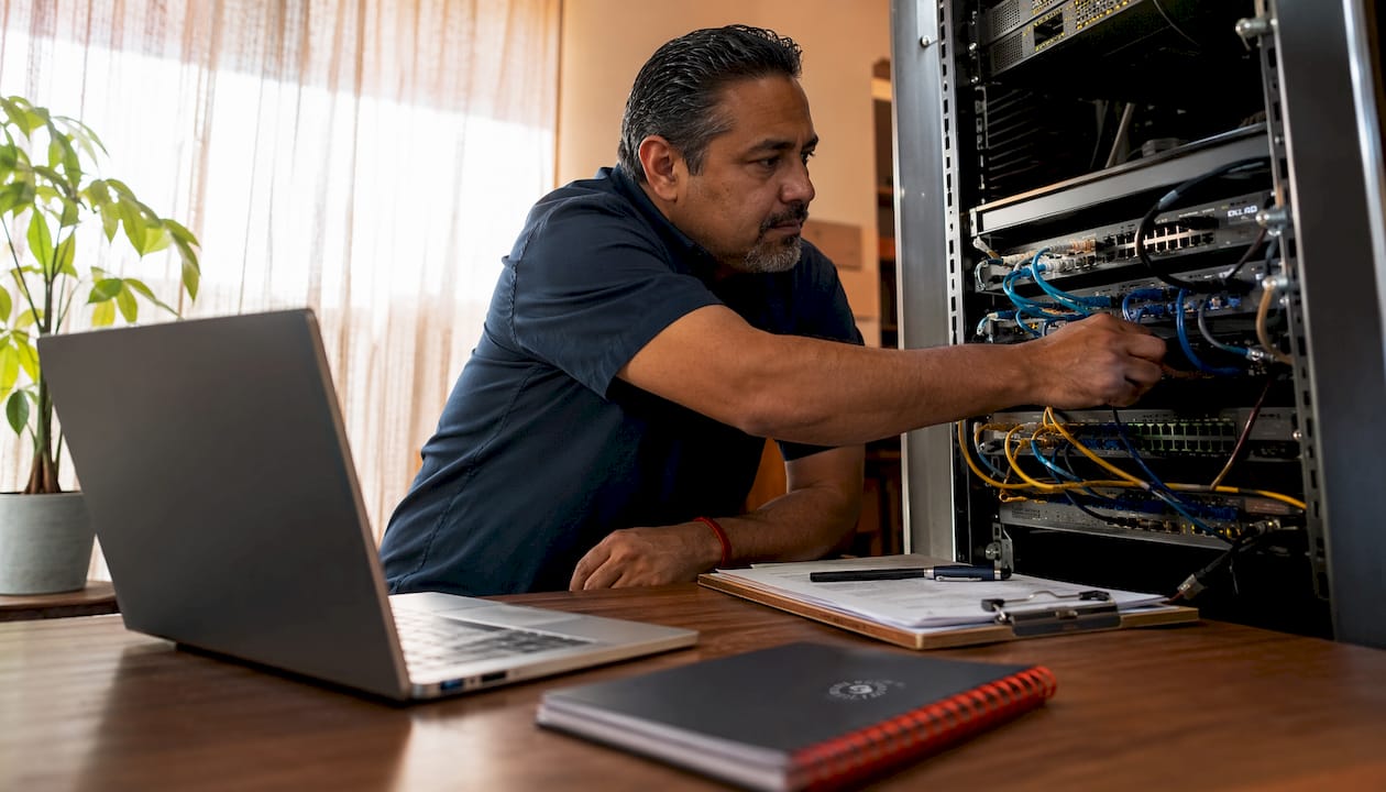 IT manager inspecting retail store network hardware