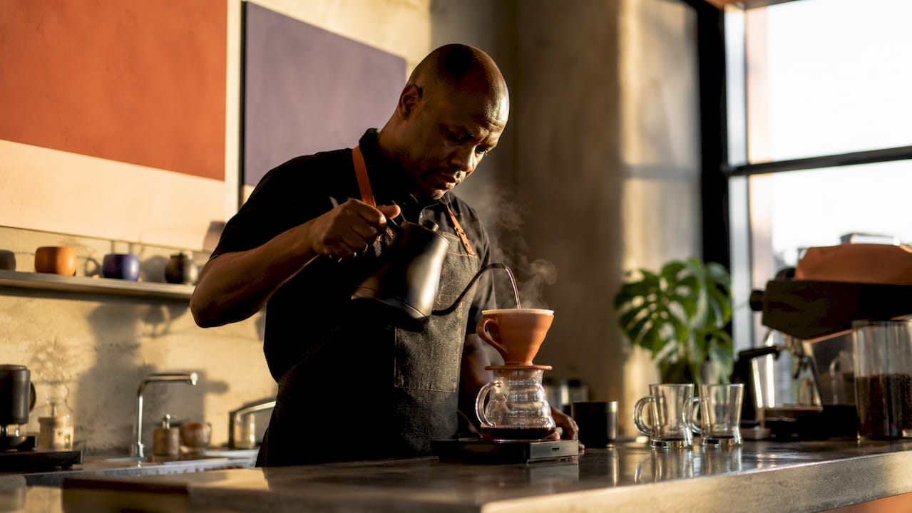 Barista brewing specialty coffee with pour-over