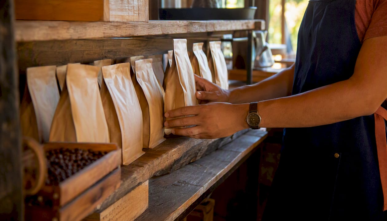 Hands arranging Fair Trade coffee bags