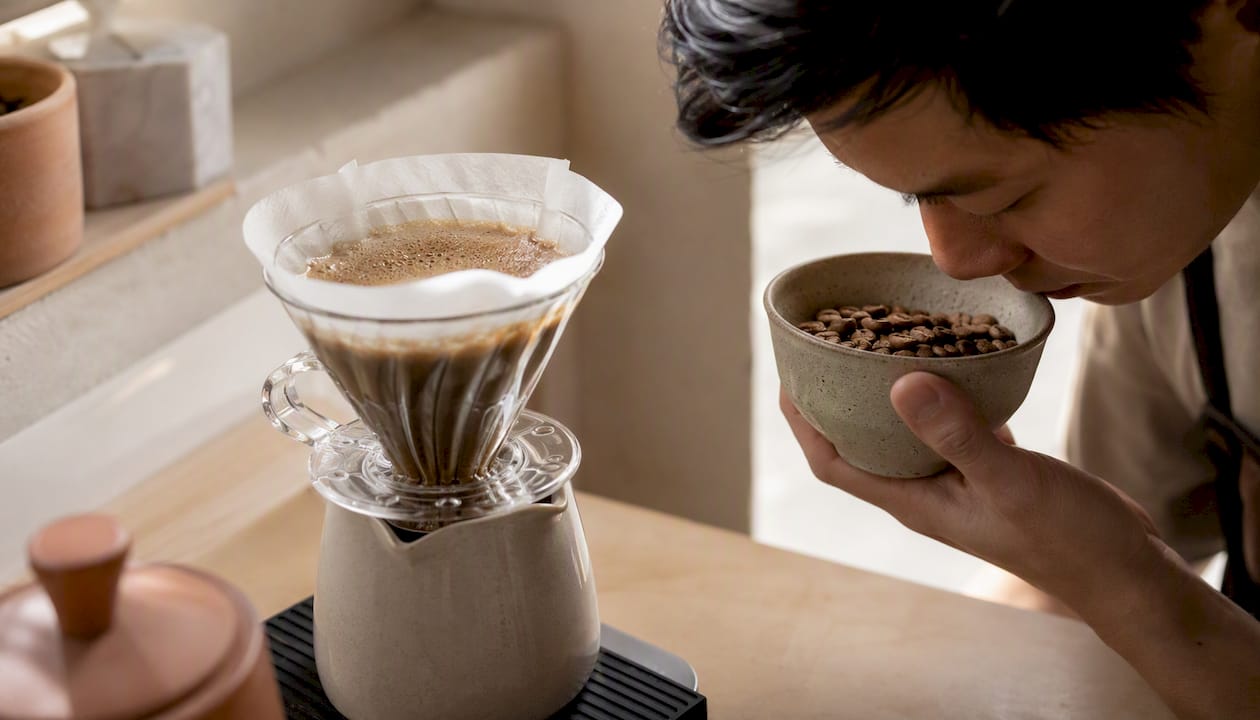 Smelling fresh coffee beans and visible bloom