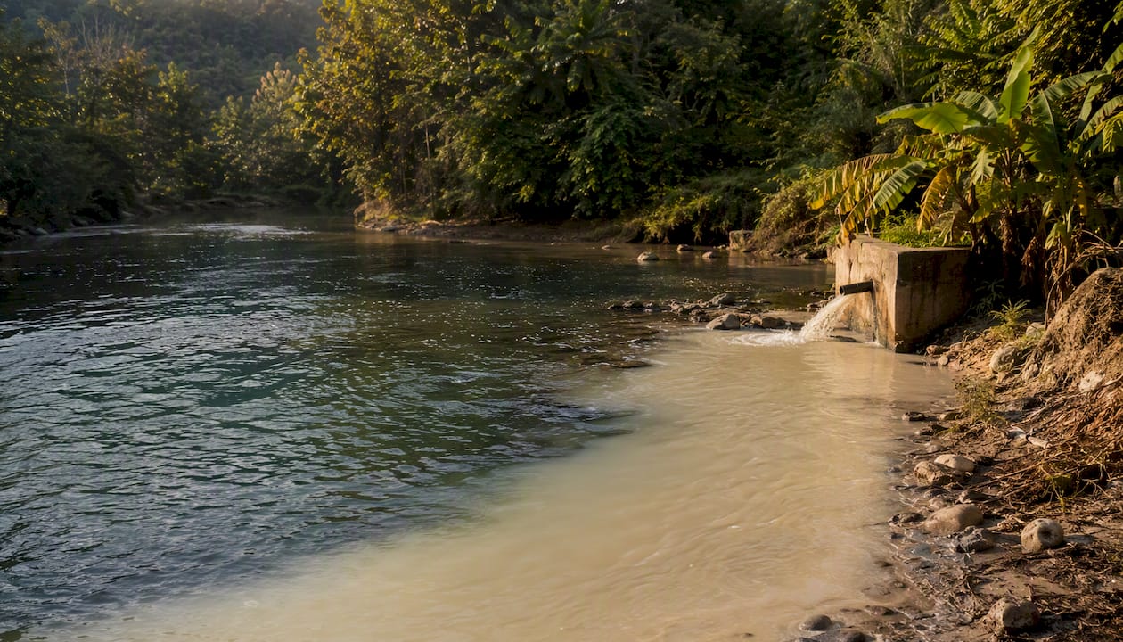 Polluted river water near coffee wet mill