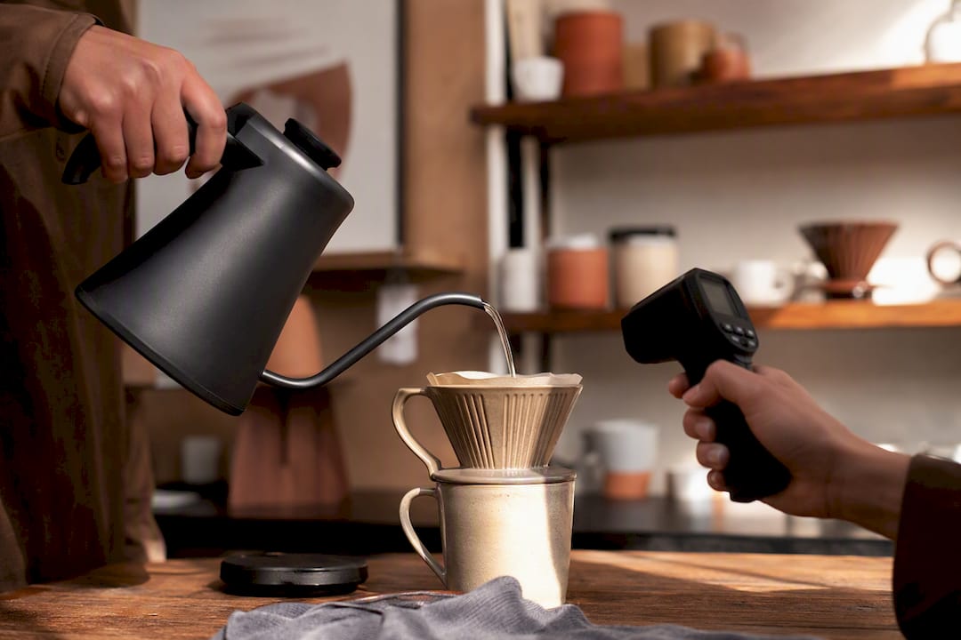 Gooseneck kettle pouring with infrared thermometer measuring temperature