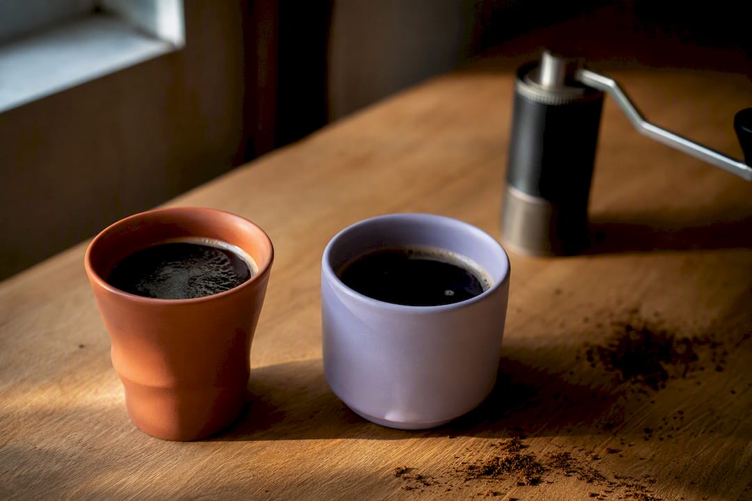 Two pour-over coffee cups side by side for tasting