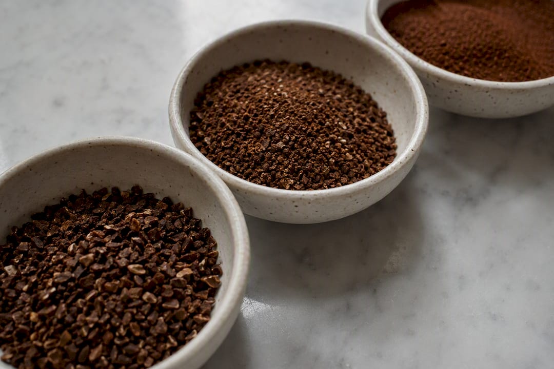 Close-up of varying coffee ground textures and sizes