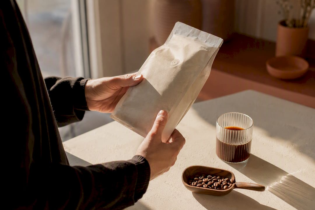 Close-up of hand holding specialty coffee bag label