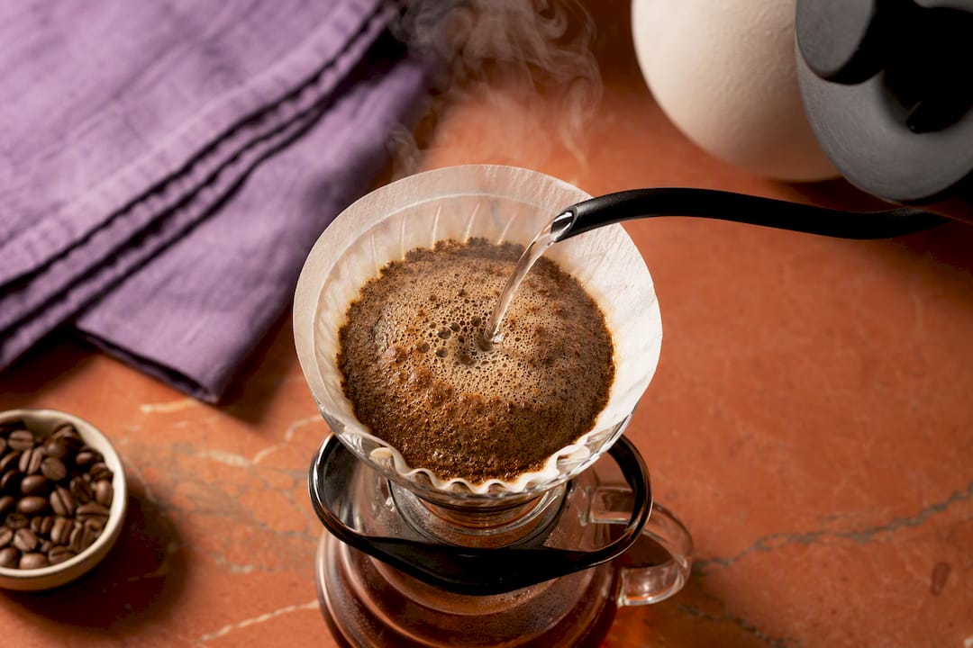 Slow pour over blooming light roast coffee
