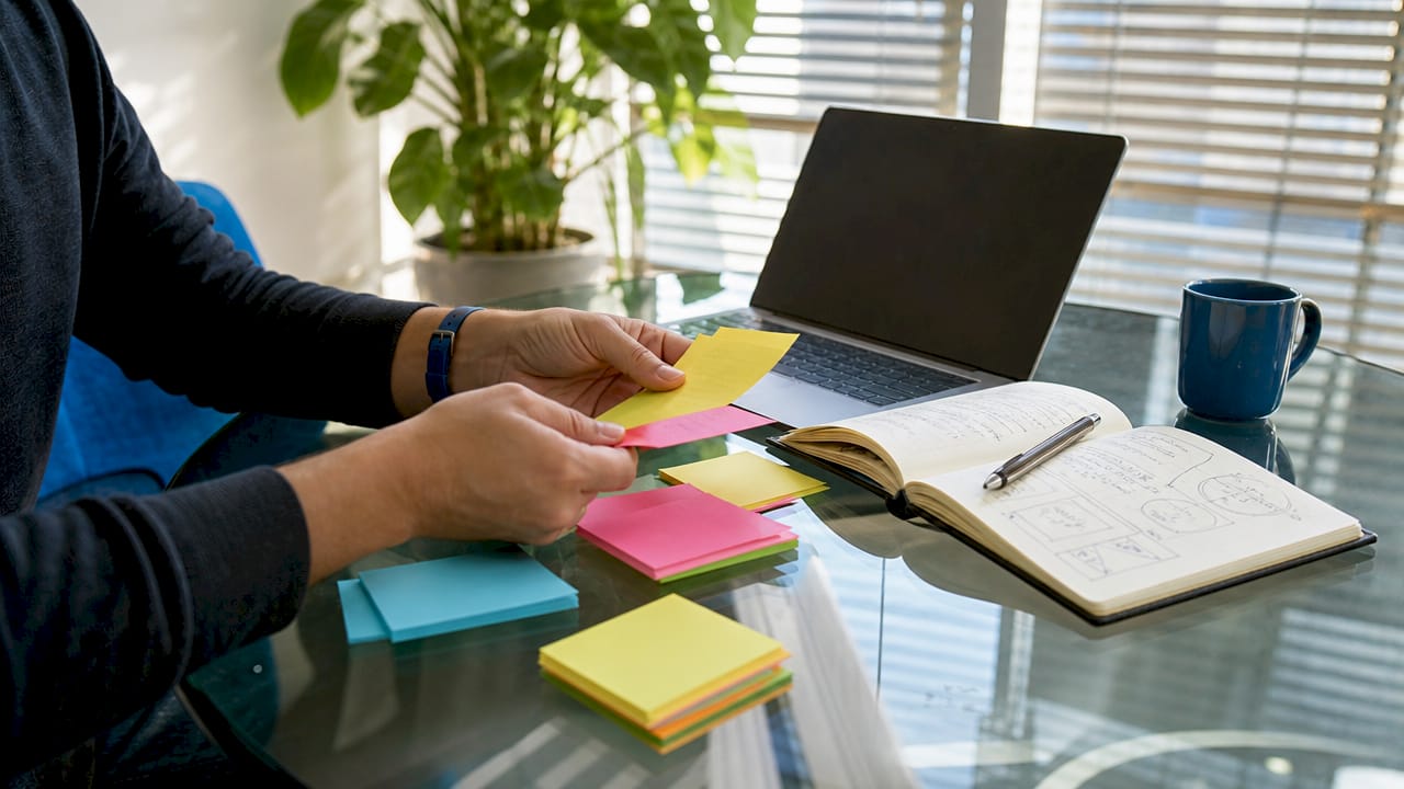 Hands holding MVP feature index cards overhead