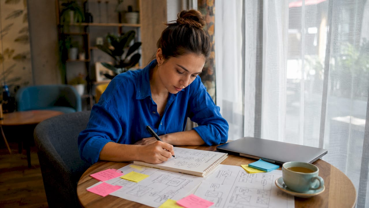 Entrepreneur sketching app workflow at desk