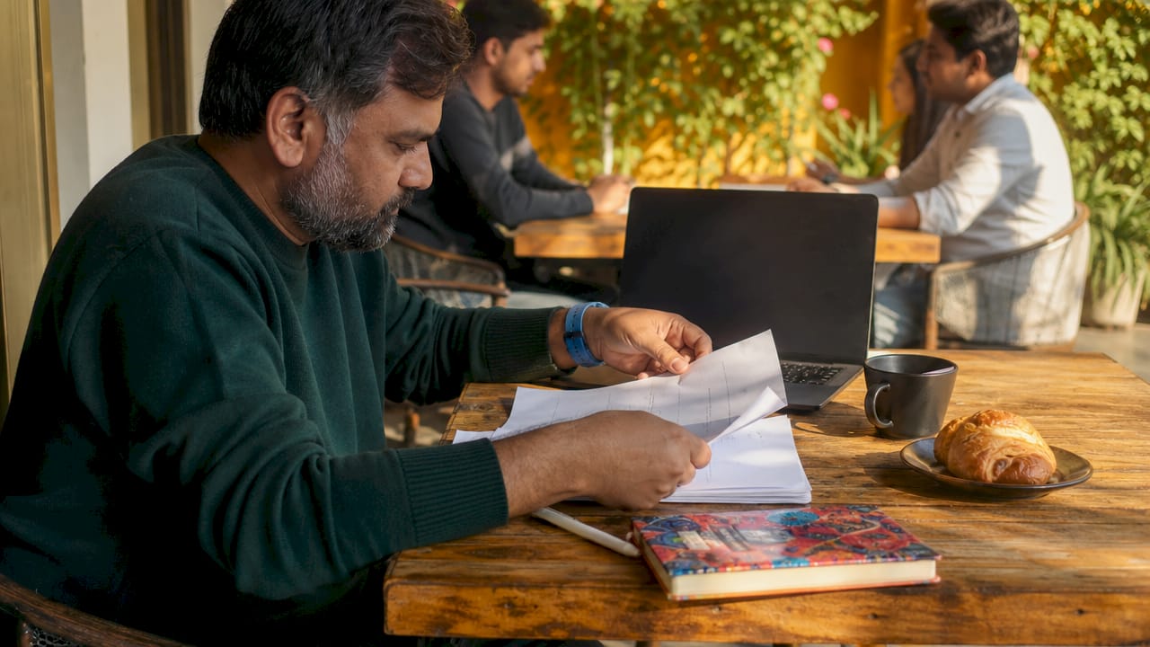 Hands compiling project brief at coffee shop