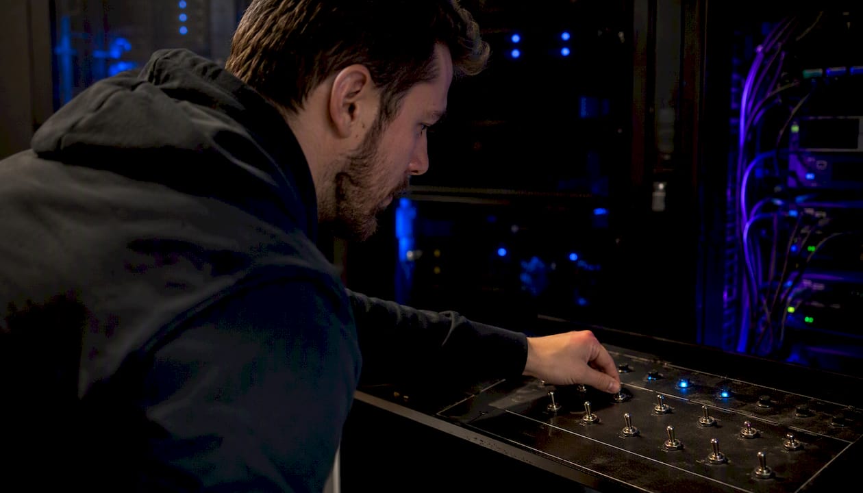 Engineer toggling switch on server hardware