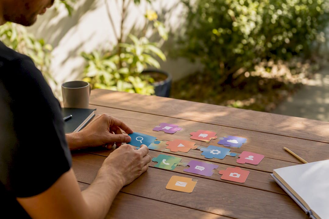 Hands arranging app workflow puzzle pieces