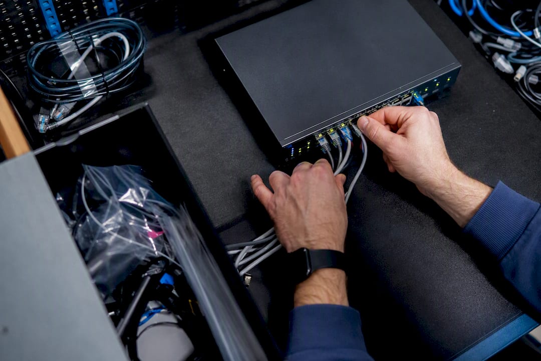 Hands configuring network security device in server room