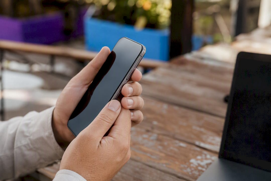 Hands holding mobile device for accessibility check