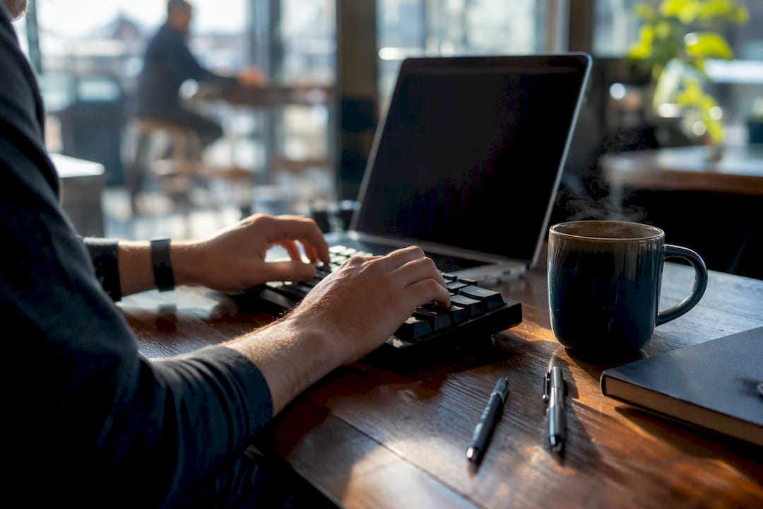 Hands typing code on a keyboard