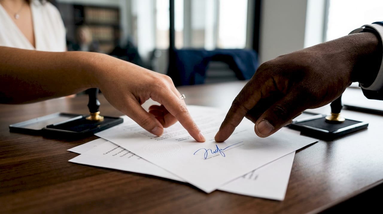 Hands pointing at notarized property documents